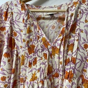 Cute, floral dress. Cream background, orange and purple flowers.